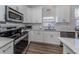 Bright kitchen featuring white cabinets, stainless steel appliances, and tile backsplash at 2160 Chenille Ct, Venice, FL 34292