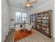Bright home office featuring a large window, built-in bookshelves, and modern desk at 2160 Chenille Ct, Venice, FL 34292