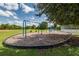 Outdoor playground area featuring swings and play structures, surrounded by lush green grass at 2160 Chenille Ct, Venice, FL 34292