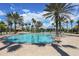 Community pool area with many chairs and umbrellas, tiki hut, and palm trees at 2160 Chenille Ct, Venice, FL 34292