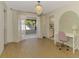 Dining room with a modern chandelier, white curtains, and a desk in the corner of the room at 2221 Pine View Cir, Sarasota, FL 34231