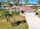 Charming single-story home with a two-car garage, landscaped front yard, and arched portico leading to the front door at 2221 Pine View Cir, Sarasota, FL 34231
