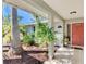 Inviting front porch featuring lush greenery, a decorative coral front door, and a charming tiled entrance at 2221 Pine View Cir, Sarasota, FL 34231