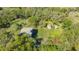 Aerial view of a house surrounded by trees and grassy landscaping at 2230 Myakka Rd, Sarasota, FL 34240
