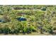 Aerial view of a home surrounded by lush trees and plenty of green grass at 2230 Myakka Rd, Sarasota, FL 34240