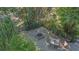 Overhead view of the backyard patio with seating, fire pit, and lush tropical landscaping at 2230 Myakka Rd, Sarasota, FL 34240