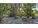 Backyard patio with seating, fire pit, and lush tropical landscaping at 2230 Myakka Rd, Sarasota, FL 34240
