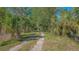 Long driveway leads to a house surrounded by mature trees and plenty of shade at 2230 Myakka Rd, Sarasota, FL 34240