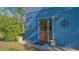 Charming outdoor shower and quaint entrance area leading through a glass-paneled wooden door at 2230 Myakka Rd, Sarasota, FL 34240