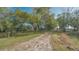 Picturesque property featuring a tree-lined drive and grassy fields at 2230 Myakka Rd, Sarasota, FL 34240