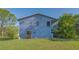 Charming two-story home with a wooden door and a serene, natural setting at 2230 Myakka Rd, Sarasota, FL 34240