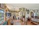 Wide angle view of the charming kitchen and dining area with wood floors and art collection at 2230 Myakka Rd, Sarasota, FL 34240