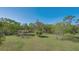Expansive lot with verdant grass and assorted trees, providing a serene and spacious setting at 2230 Myakka Rd, Sarasota, FL 34240