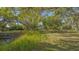 Picturesque land featuring lush green grass and mature trees offering shade and privacy at 2230 Myakka Rd, Sarasota, FL 34240