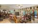 Open living room featuring tiled floors, ceiling fan, bar, and doors to the outdoors at 2230 Myakka Rd, Sarasota, FL 34240