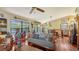 Cozy living room featuring hardwood floors, masks, sculptures, and abundant natural light at 2230 Myakka Rd, Sarasota, FL 34240