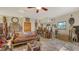 View of the living room with tile flooring, ceiling fan, and wooden bar with stools at 2230 Myakka Rd, Sarasota, FL 34240