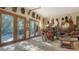 Eclectic living room showcasing decor with a variety of unique statues and wooden furniture at 2230 Myakka Rd, Sarasota, FL 34240