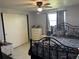 Comfortable bedroom with ceiling fan, window, closet, and a black metal bed frame, offering a cozy retreat at 22337 Olean Blvd, Port Charlotte, FL 33952
