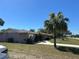 Street view of the home and a lush lawn at 22337 Olean Blvd, Port Charlotte, FL 33952