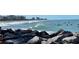 Ocean view featuring surfers enjoying the waves against a backdrop of city buildings at 22337 Olean Blvd, Port Charlotte, FL 33952