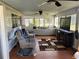 Inviting sunroom with comfortable seating, ceiling fan, and large windows, creating a cozy and bright atmosphere at 22337 Olean Blvd, Port Charlotte, FL 33952