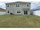 Spacious backyard with lush green grass, offering plenty of room for activities at 2409 Sand Gables Trl, Bradenton, FL 34208