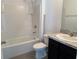 Bright bathroom with a shower-tub combo, white tiles, and vanity with storage at 2409 Sand Gables Trl, Bradenton, FL 34208