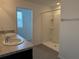 Bathroom with dual sinks, a shower stall, and tile flooring, offering a functional and stylish space at 2409 Sand Gables Trl, Bradenton, FL 34208