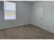Bright bedroom with a window view and a neutral-colored carpet and light walls at 2409 Sand Gables Trl, Bradenton, FL 34208