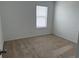 Cozy bedroom featuring neutral carpet, a window, and ample natural light at 2409 Sand Gables Trl, Bradenton, FL 34208