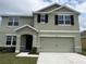 Inviting two-story home featuring a well-maintained lawn and a two-car garage at 2409 Sand Gables Trl, Bradenton, FL 34208