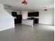 Open-concept living space showcasing a modern kitchen with an island and tile flooring at 2409 Sand Gables Trl, Bradenton, FL 34208