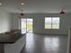 Open living space with tile flooring, a sliding glass door, and an expansive window showcasing a view at 2409 Sand Gables Trl, Bradenton, FL 34208