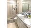 Bathroom featuring glass enclosed shower, granite countertops, and dual vanities at 2846 Midnight Pearl Dr, Sarasota, FL 34240