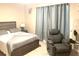Comfortable bedroom featuring soft carpeting, a cozy armchair, and ample natural light at 2846 Midnight Pearl Dr, Sarasota, FL 34240