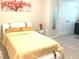 Comfortable bedroom showcasing neutral walls, a queen-size bed, and an art piece hanging on the wall at 2846 Midnight Pearl Dr, Sarasota, FL 34240