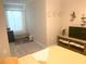 Serene bedroom with a window, storage bench, television and neutral decor for a relaxing ambiance at 2846 Midnight Pearl Dr, Sarasota, FL 34240