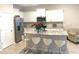 Well-appointed kitchen boasting stainless steel appliances, granite countertops, and eat-in bar area at 2846 Midnight Pearl Dr, Sarasota, FL 34240