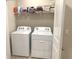 Efficient laundry room featuring a Whirlpool washer and dryer, plus convenient shelving for storage at 2846 Midnight Pearl Dr, Sarasota, FL 34240