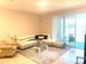 Inviting living room featuring stylish furniture, neutral color palette, and sliding glass door to patio at 2846 Midnight Pearl Dr, Sarasota, FL 34240