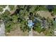 Aerial view of a house surrounded by lush greenery and waterfront on the property at 3466 Tanglewood Dr, Sarasota, FL 34239