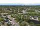 Wide aerial view of a residential neighborhood with water features and commercial areas nearby at 3466 Tanglewood Dr, Sarasota, FL 34239