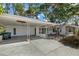 Exterior view of the home showcasing the carport and front yard at 3466 Tanglewood Dr, Sarasota, FL 34239