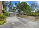 Traditional single-story home with a long driveway and mature trees at 3466 Tanglewood Dr, Sarasota, FL 34239