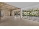Spacious living room with exposed beam ceiling, tile floors, and sliding glass doors to the outside at 3466 Tanglewood Dr, Sarasota, FL 34239