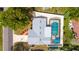 Aerial view shows the house, roof, pool with screen enclosure, and surrounding landscaping at 3502 18Th Avenue W Dr, Bradenton, FL 34205