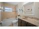 Bathroom featuring a tub, and a marble-top dark wood vanity cabinet at 3502 18Th Avenue W Dr, Bradenton, FL 34205