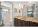 Bathroom view featuring a dark brown vanity, a large mirror, and a shower behind the toilet at 3502 18Th Avenue W Dr, Bradenton, FL 34205