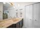 Bathroom with a marble countertop, a large mirror, and built-in shelves at 3502 18Th Avenue W Dr, Bradenton, FL 34205